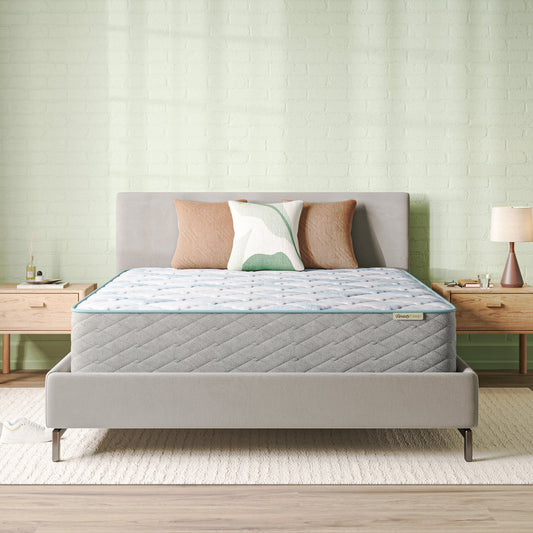 Beautysleep Mattress in a grey bedframe with 3 pillows on top of it within a bedroom setting