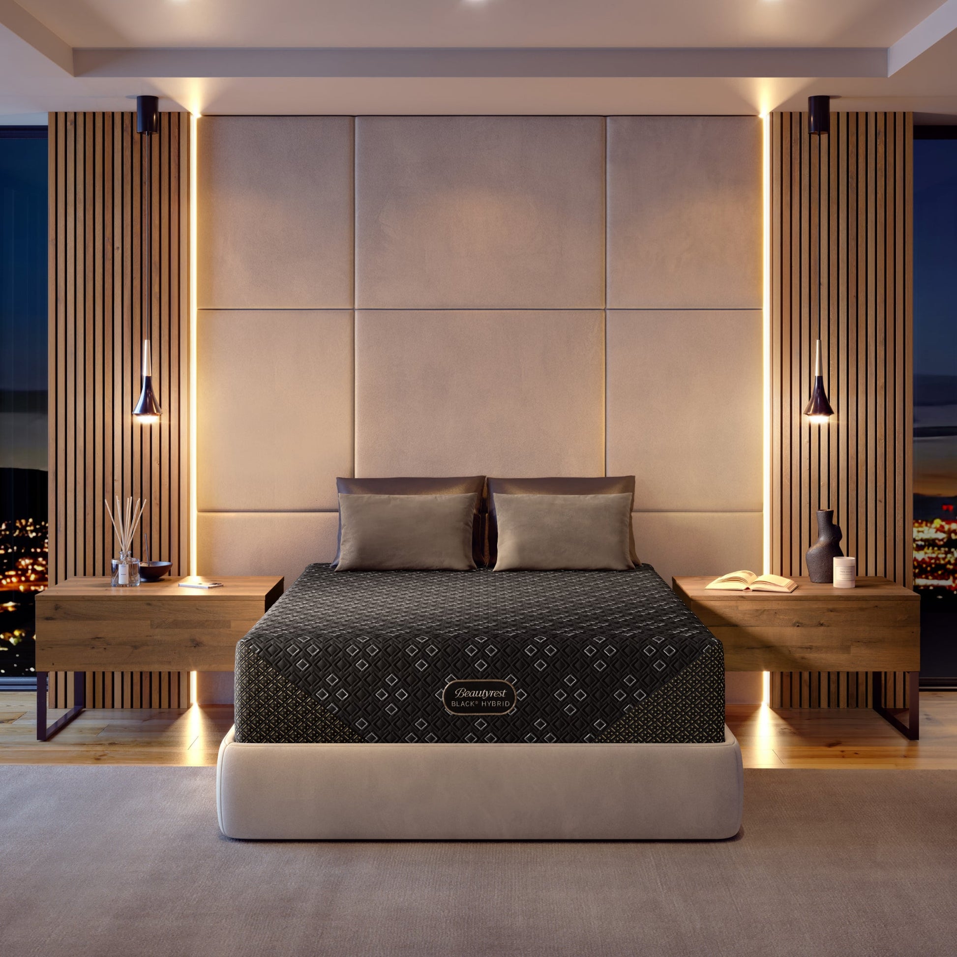 Modern bedroom with a Beautyrest Black Hybid XCS mattress in a beige bed frame and nightstands, featuring a brand logo on the mattress.