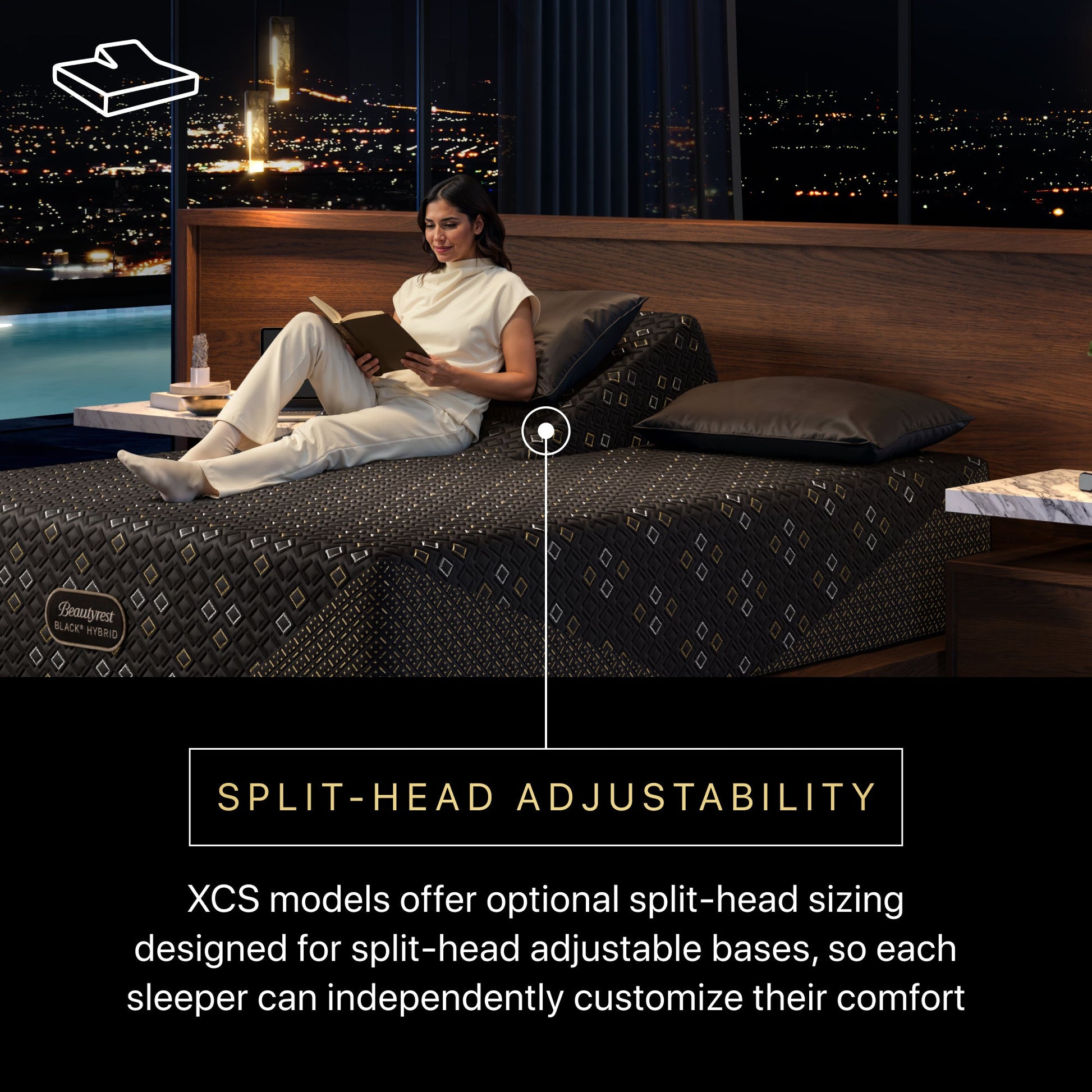 Woman reading a book on a Beautyrest Black Hybid XCS split-head mattress with an adjustable bedframe with a cityscape view.